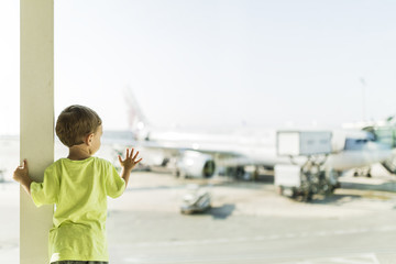 Child waiting for his plane at the airport of Barcelona