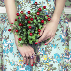 Woman's hands with bouquet of berry