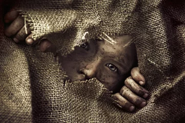 Fototapeten Artistic portrait of a poor little boy © konradbak