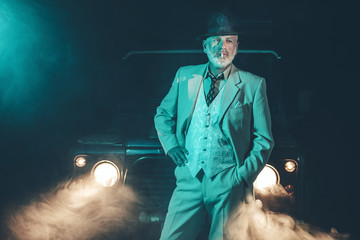 Senior Businessman Standing In Front his Vehicle
