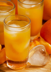 Freshly squeezed apricot juice with ice, selective focus