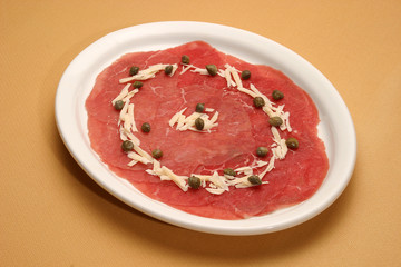 Raw meat selection on wooden cutting board with knife