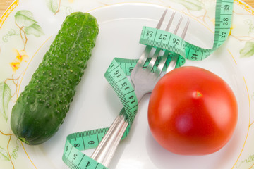 Cucumber and tomato with measuring