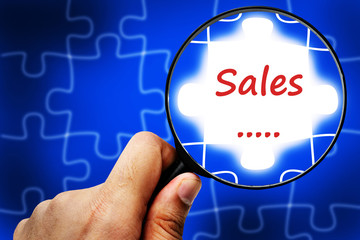 Sales word. Magnifier and puzzles.