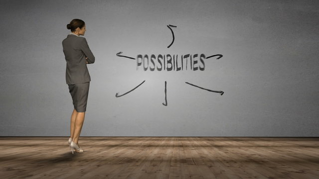 Businesswoman looking at wall with possibilities brainstorm 