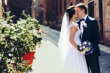 romantic gentle luxury brunette bride and groom are walking at t