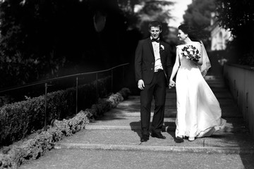 luxurious bride and groom walking spring park of tivoli italy
