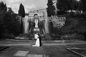 cute couple full in love on the background wonderful fountain in