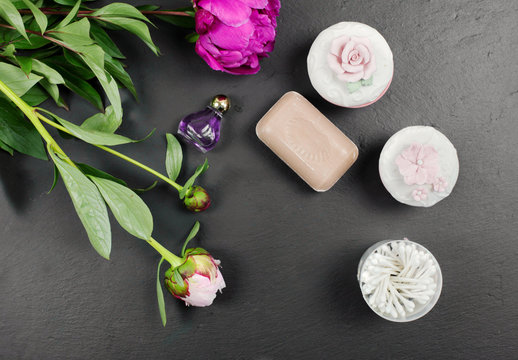 beauty accesories with peony essence and fresh flowers