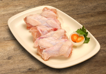 Fresh chicken parts, wings, legs, meat in ice cube trays.
