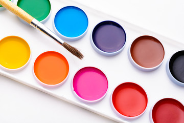 The palette of watercolor paints and brush