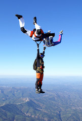 Skydiving photo. Maneuvers in free fall. Formation friends.