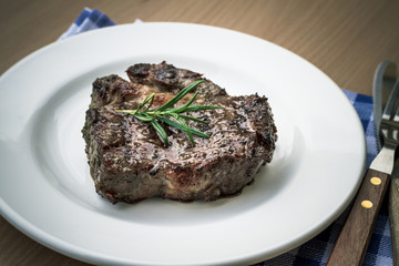 Juicy grilled rib eye steak with cutlery
