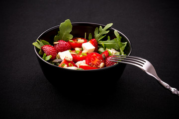 Strawberry tomato salad with feta cheese, fork