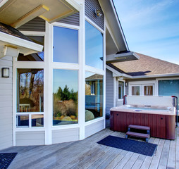 Traditional back deck with tall windows, and jacuzzi tub.
