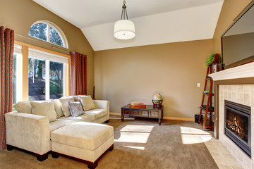 Perfect family living room with carpet, and hanging light fixtur