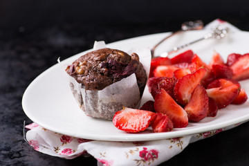 Chocolate muffins with nuts and cherry