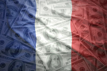 colorful waving french flag on a american dollar money background