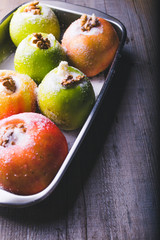 Apples with stuffed with walnuts and sugar, ready to be baked