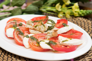 Plate of tomato and curd, cheese. Sliced. Italian cuisine. Appetizer