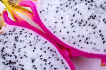 Dragon fruit sliced shot cropped diagonally side to side on a white background