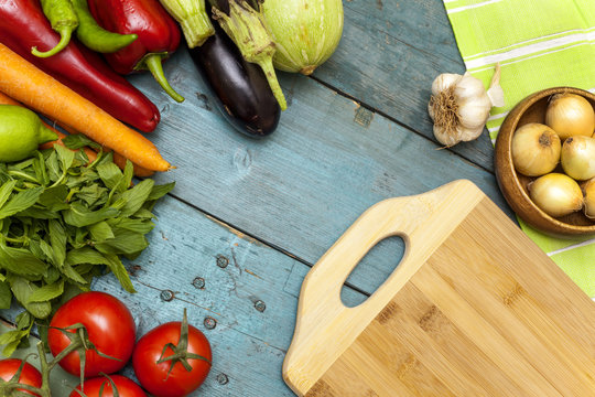 Assortment of fresh vegetables and chopping board