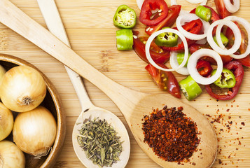 Paprika powder in wooden spoon and salad