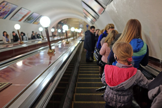 MOSCOW, RUSSIA  -  APRIL 12, 2015: Sokolnicheskaya line - the first line of the Moscow metro. The girl in headphones on the escalator in the metro