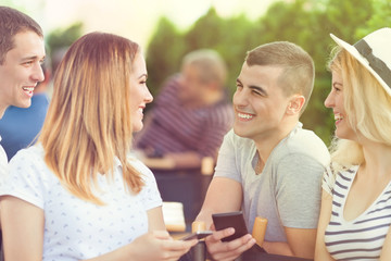Young man flirting with a pretty young girl in a cafe