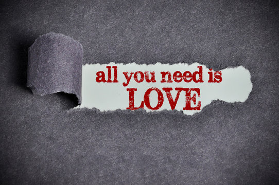 all you need is love word under torn black sugar paper
