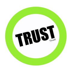 Trust black stamp text on green