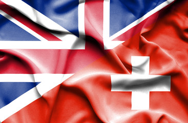 Waving flag of Switzerland and Great Britain