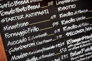 Italian menu chalk board ouside a restaurant in Italy photo
