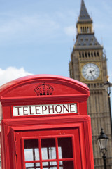 Fototapeta na wymiar London red telephone box booth with Big Ben clock tower in the background photo vertical