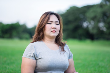 Woman meditating in garden