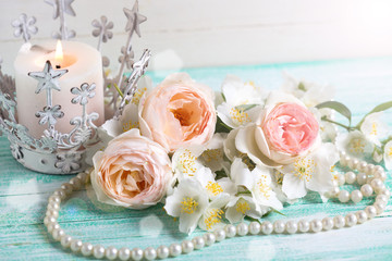 Sweet pastel  roses, jasmine flowers  and candle