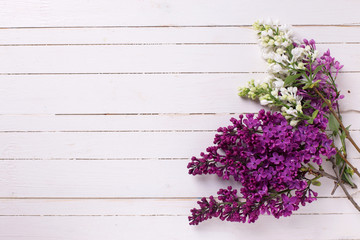 Lilac flowers on wooden background.