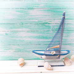 Decorative sailing ship and marine items on wooden background.