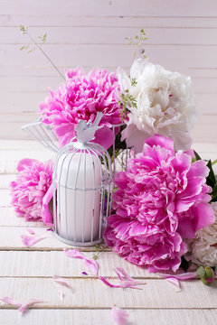 Background with fresh peonies flowers and decorative candle