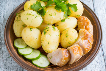 Young boiled potatoes with dill, sausage, cucumber and parsley