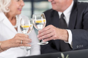 Senior business pair celebrating