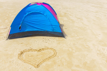 Tent and heart on the beach
