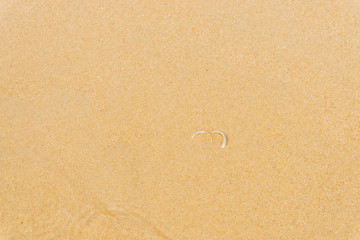 Couple rings in the sand beach
