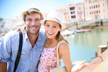 Fototapeta na wymiar Portrait of cheerful couple in summer vacation at seaside resort