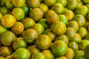 Heap of fresh ripe green tangerines for sale in Thailand market