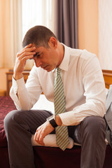 Businessman sitting in hotel room and thinking