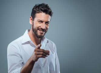 Fashionable man pointing at camera