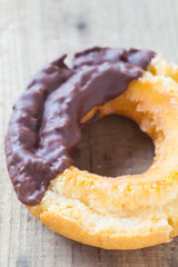 Old fashion chocolate donut on wood background