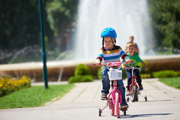happy boy learning to ride his first bike