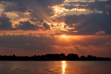Naklejka na ściany i meble Summer Sunrise With Beautiful Cloudy Sky Over Calm Lake Water